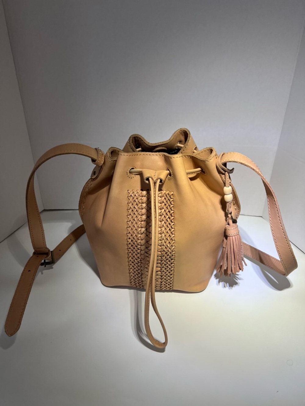 The Sak Beige/Tan Woven Drawstring Bucket Crossbody with Tassel